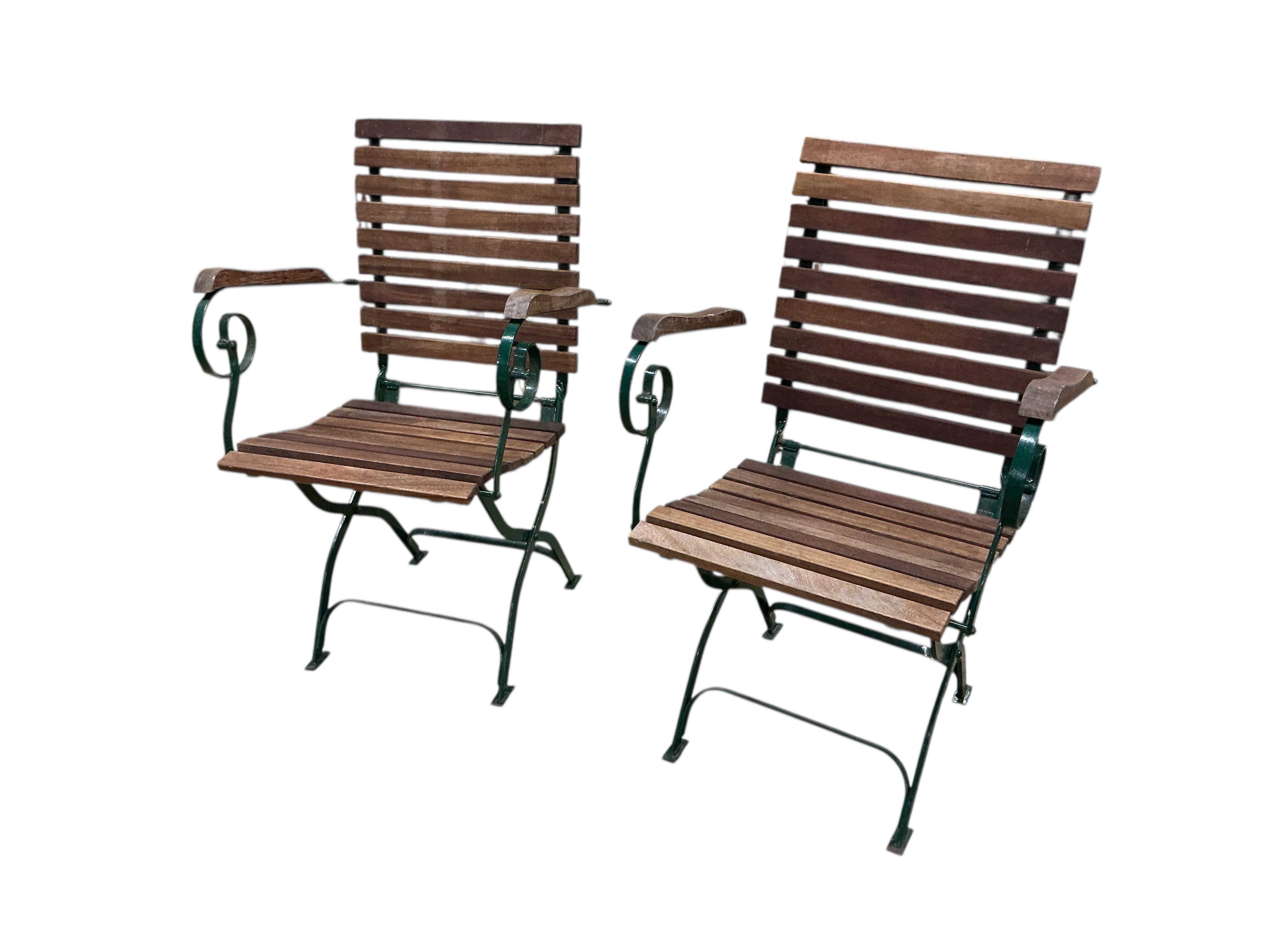 A set of four slatted teak and green painted wrought iron folding garden chairs, width 58cm, depth 50cm, height 91cm